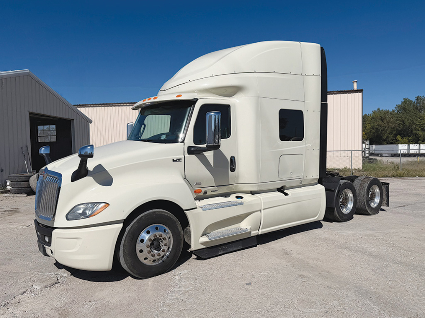 Truck: 2022 International LT625 semi-truck tractor in white, side view with sleeper cab and dual rear axles.