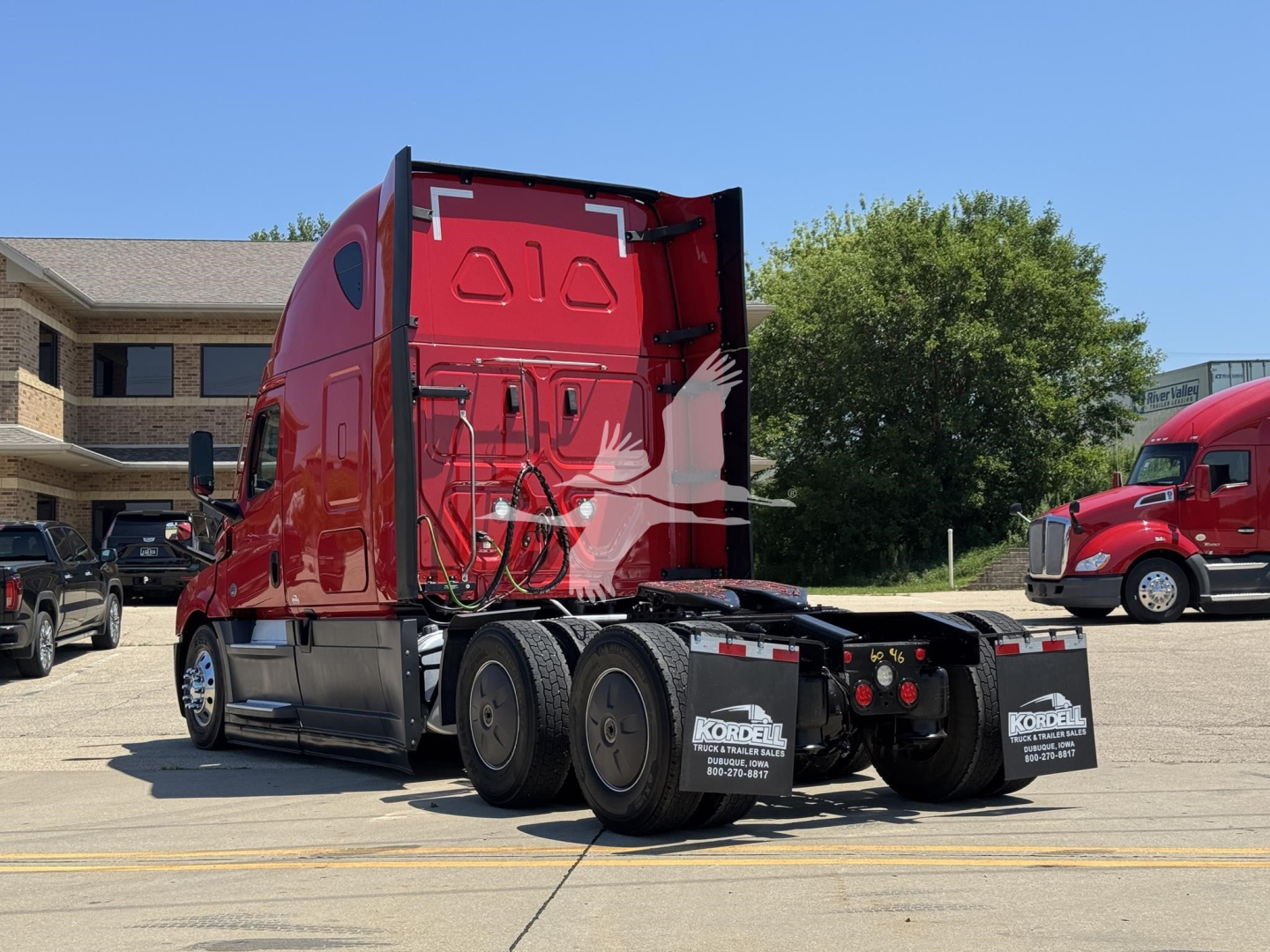 Freightliner Cascadia 126 sleeper tractor rear view showing fifth wheel area and rear dual axles with mud flaps.