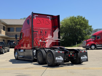 Freightliner Cascadia 126 sleeper tractor rear view showing fifth wheel area and rear dual axles with mud flaps.