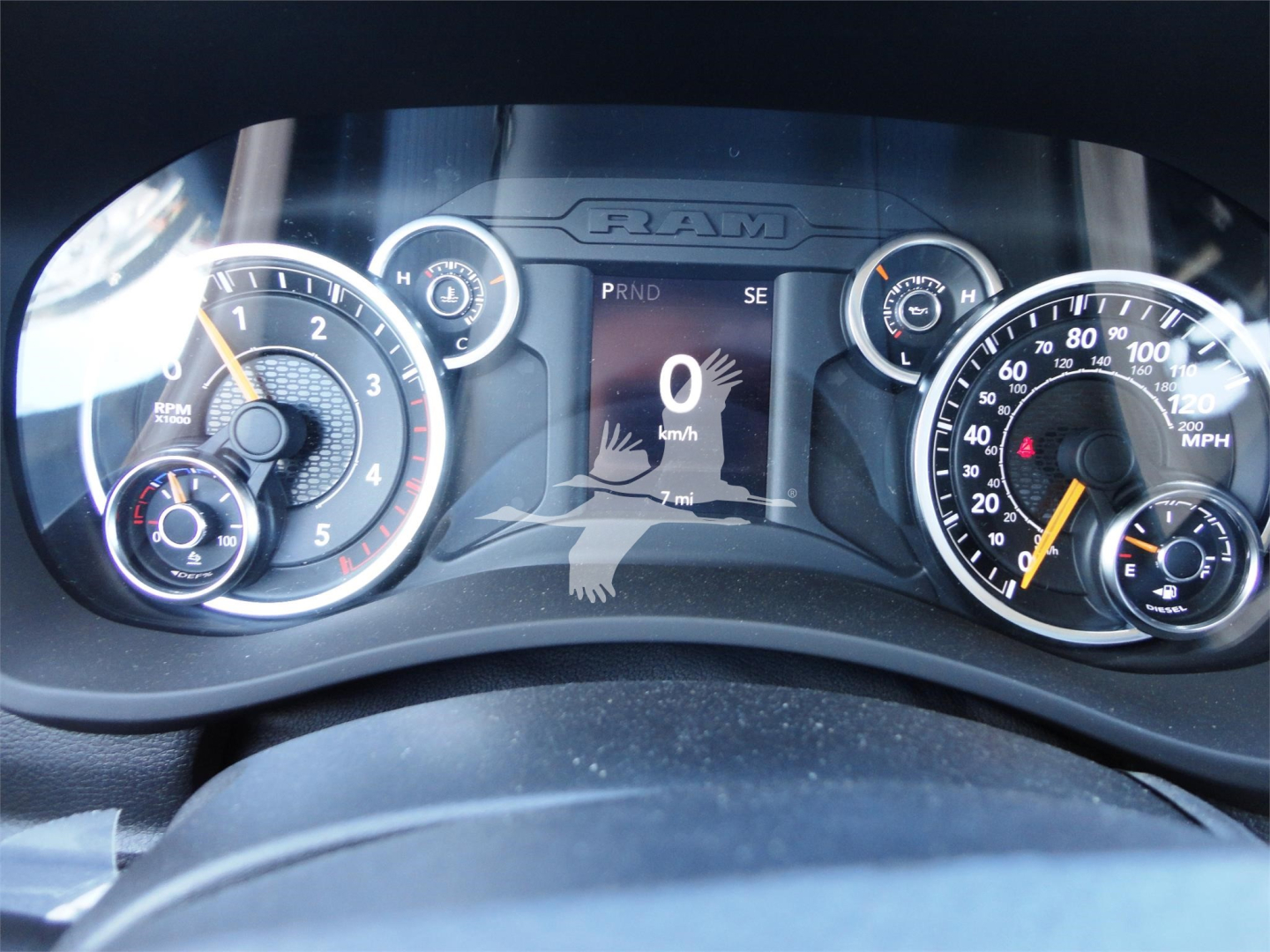 Ram 5500 dash view showing instrument cluster, digital speedometer reading 0, with left tachometer and right speedometer gauges.