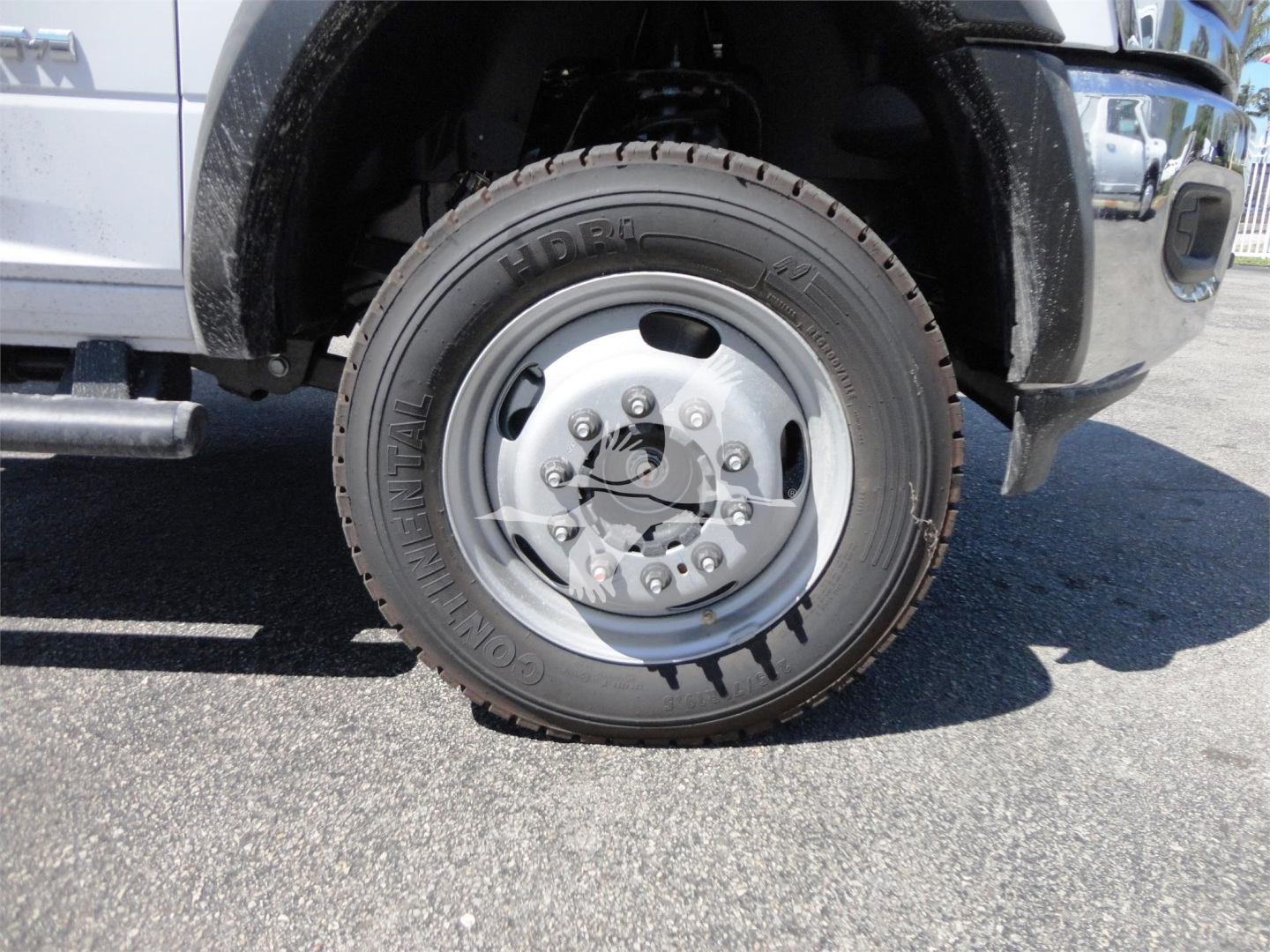 Front wheel and tire of a 2024 Ram 5500 HD hooklift truck showing a Goodyear Commercial tire and steel wheel.