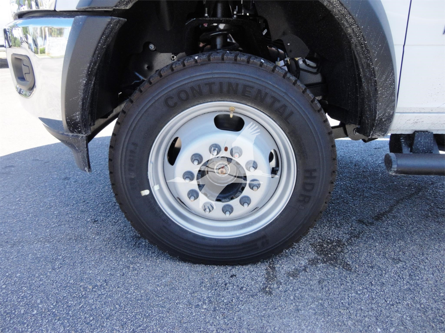 Truck front wheel and fender showing Continental HD tire on steel rim