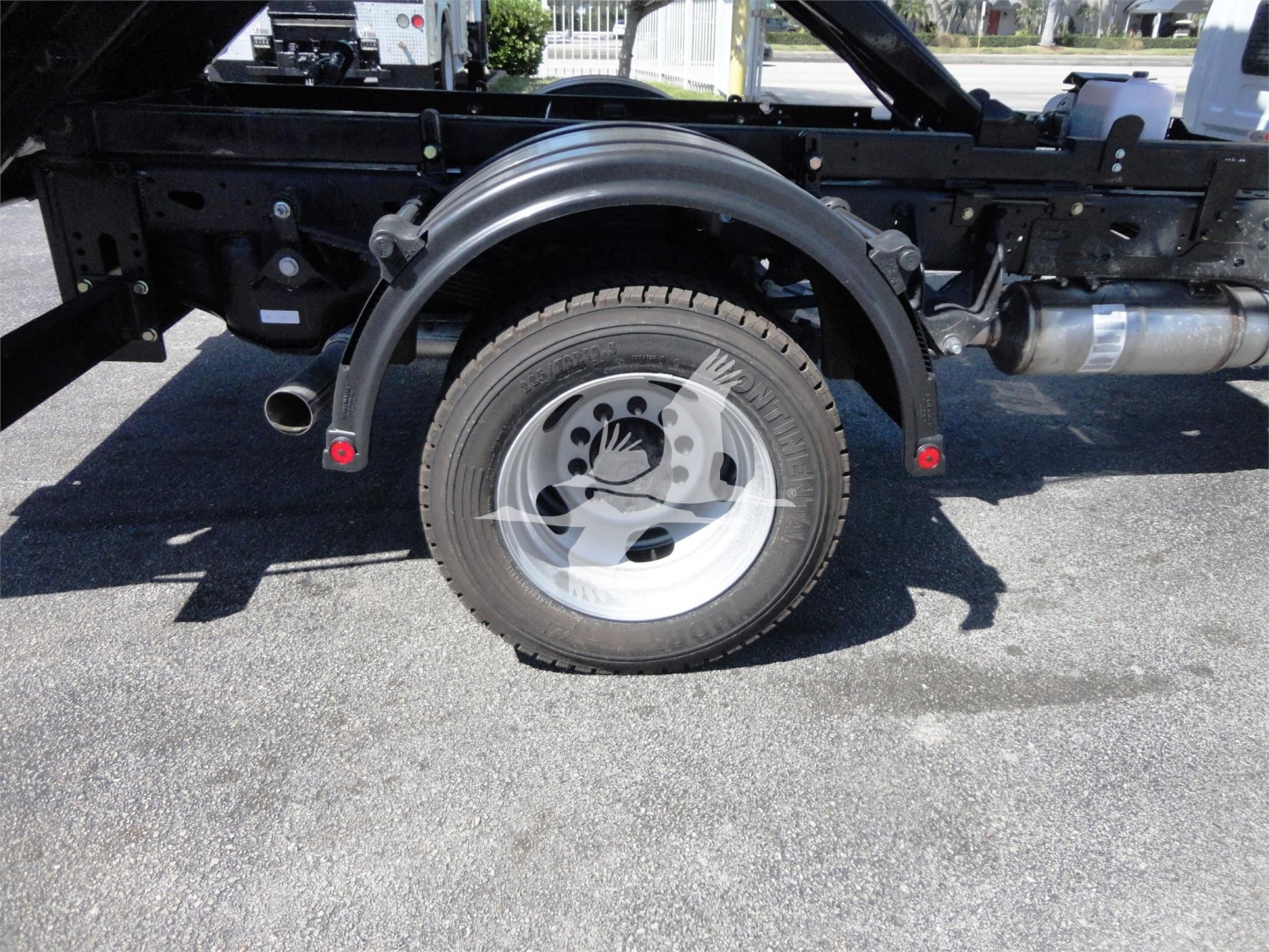 Ram 5500 HD chassis rear wheel and hooklift setup showing single rear wheel, fender, and undercarriage components.