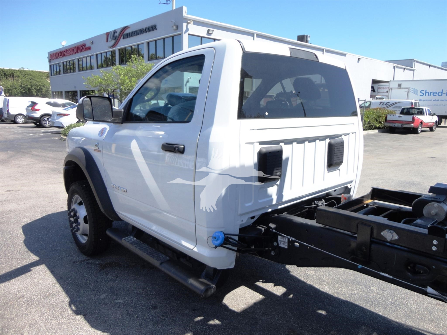Ram 5500 HD utility truck cab and chassis shown from rear left side.