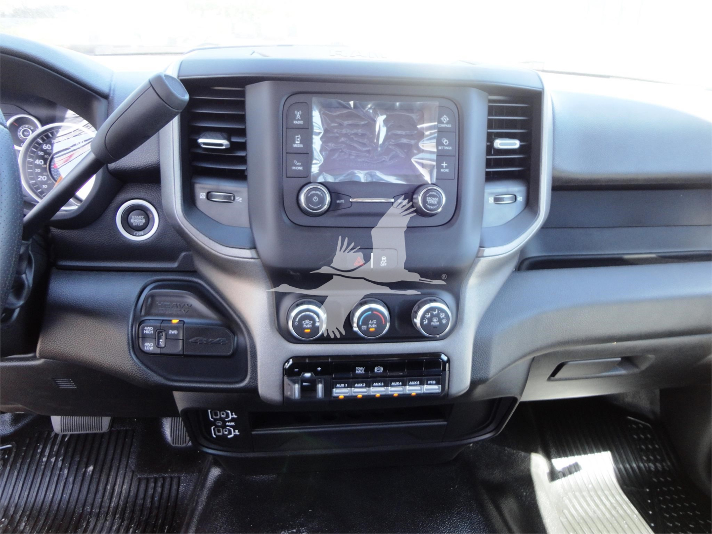 Ram 5500 HD truck interior showing center touchscreen, dual climate controls, and steering wheel with dash area.