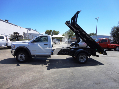 Ram 5500 HD truck in serviceable condition with a tipper/dump bed raised at a dealership lot.