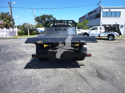 Ram 5500HD hooklift truck rear view showing flatbed with hydraulic hooks and bumper lights.