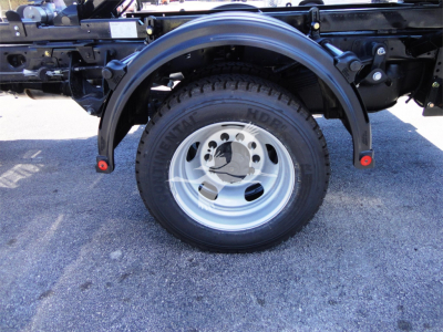 Wheel and fender of a Ram 5500 truck showing utility frame and tire.