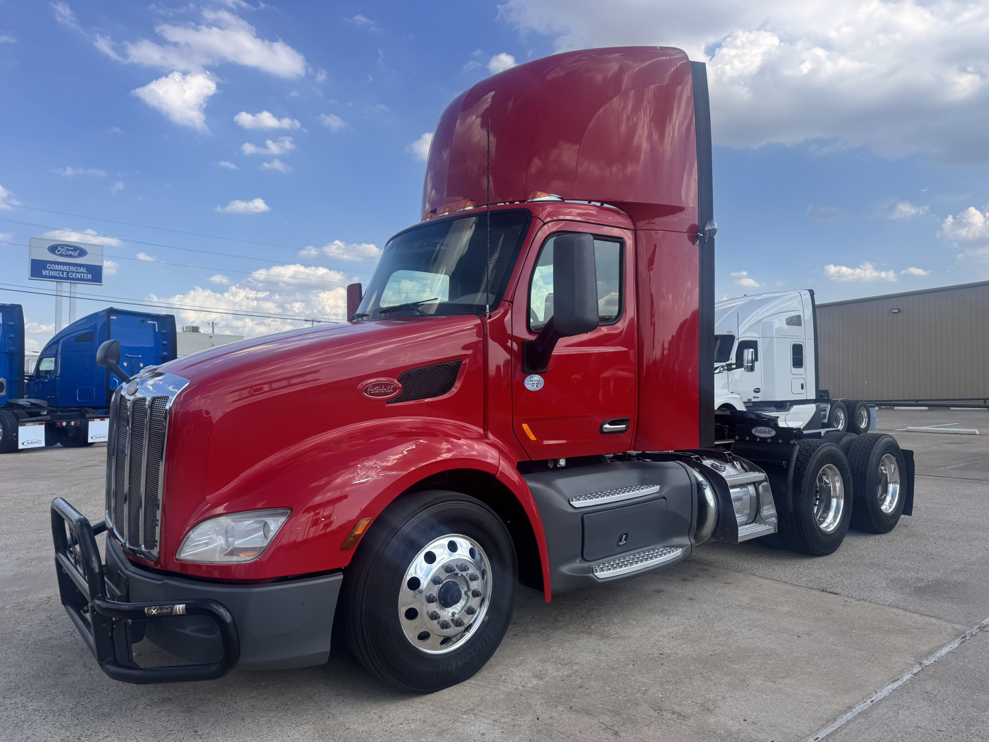 Peterbilt 579 2021 conventional daycab tractor in red, side view, with dual rear axles and sleeper cab, VIN 1XPBD49X0MD756073 visible.