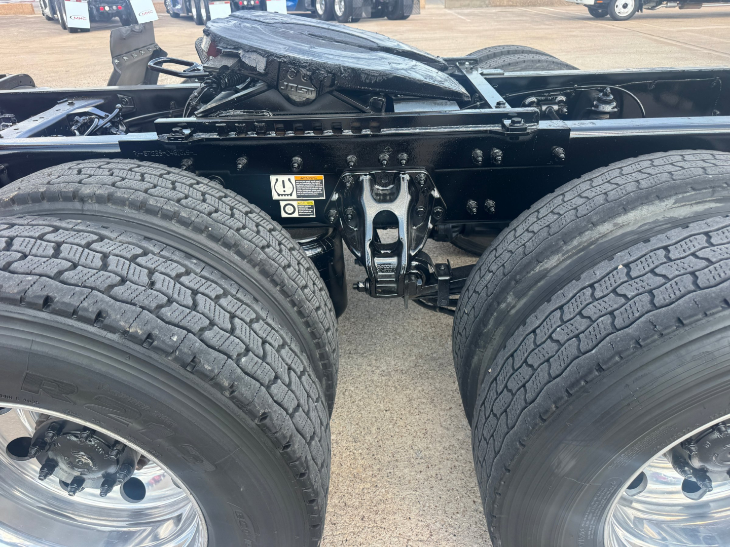 Dual rear truck axle with fifth wheel mount and dual tires on Peterbilt 579 chassis, view of frame and suspension components.