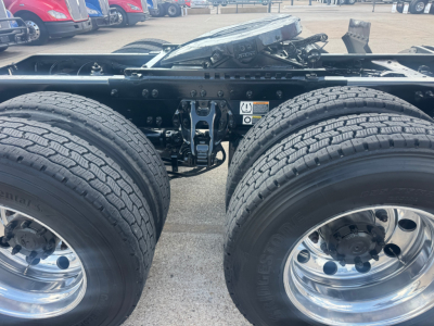 Peterbilt 579 chassis showing dual rear axles and chrome wheel rims; view focuses on the rear tandem area with suspension components and frame.