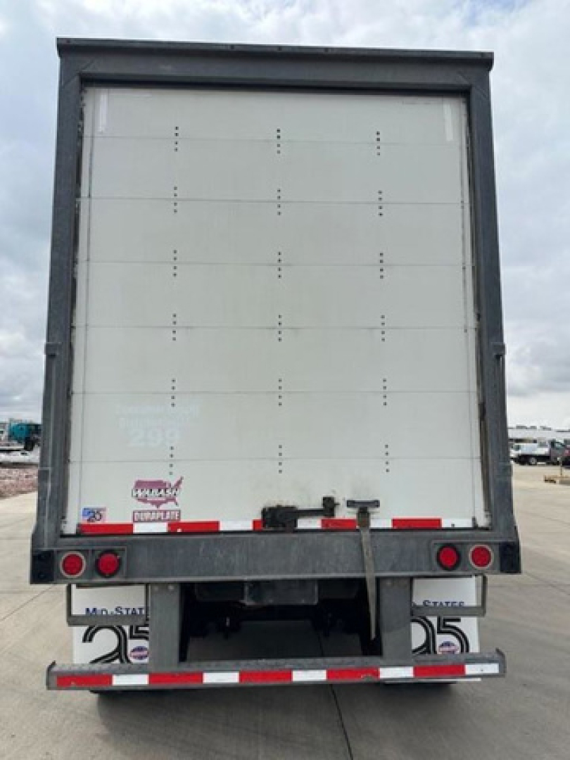 Rear view of a 2016 Wabash van trailer showing rear doors, lighting, and bumper with reflective striping.
