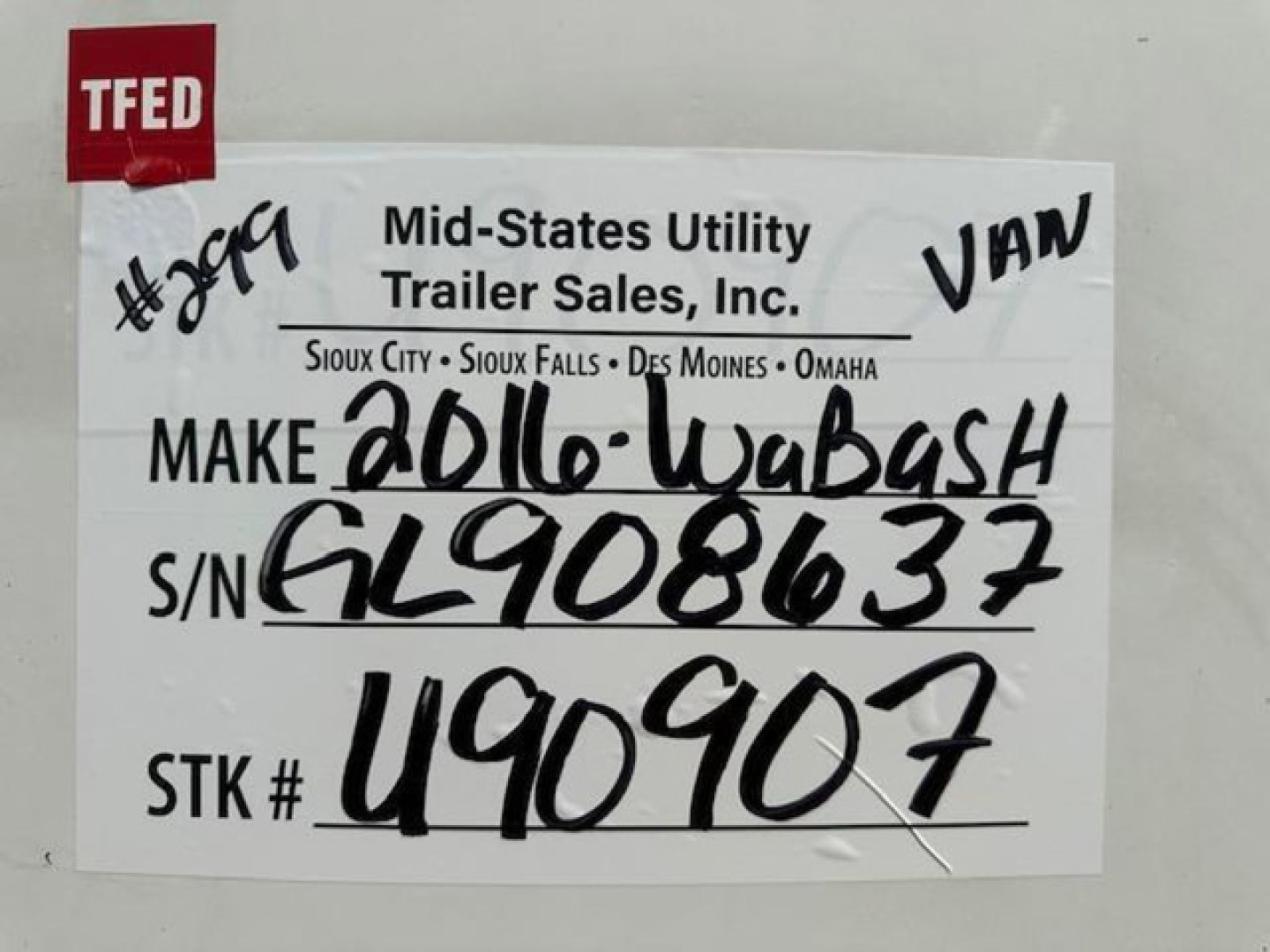 Mid-States Utility Trailer Sales sign with handwritten VIN 1JJV532D4GL908637, stock U90907, make 2016-Wabash, S/N GL908637, STK U90907, TFED sticker in corner.