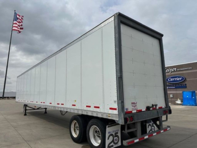 Trailer side and rear showing 2016 Wabash van box trailer with dual rear axles and ramp door.