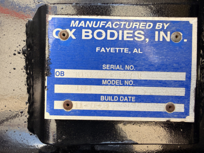 Label on Mack GU713 component showing Manufactured by Cox Bodies, Inc., Fayette, AL, with fields for OB, Serial No., Model No., Build Date.