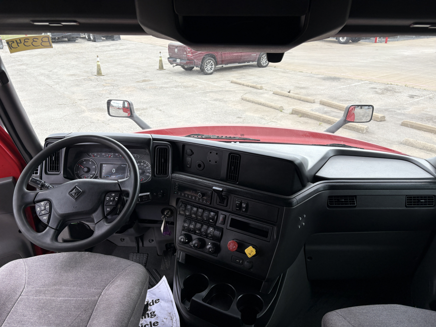 Cab interior of 2022 International LT trucks showing steering wheel, dashboard controls, and center console with gauges and switches.