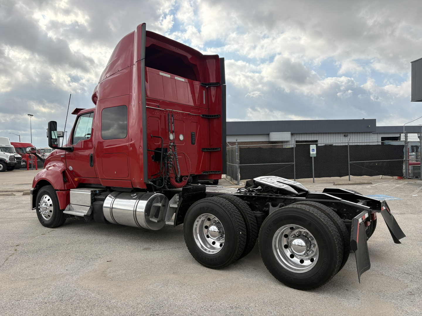 Truck cab with red sleeper and dual rear axles, side view showing fuel tanks and chassis, International LT model, stock B3345P.