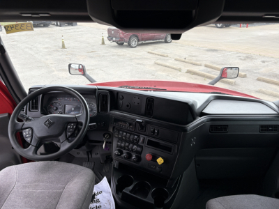 Cab interior of 2022 International LT trucks showing steering wheel, dashboard controls, and center console with gauges and switches.