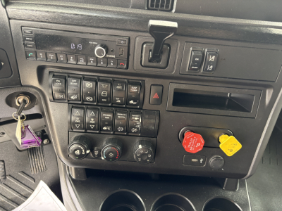 Truck dash panel showing radio, climate controls, and various buttons with red and yellow placeholder knobs visible.