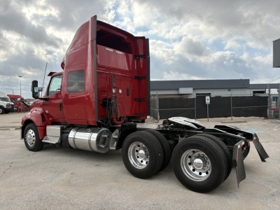 Truck cab with red sleeper and dual rear axles, side view showing fuel tanks and chassis, International LT model, stock B3345P.