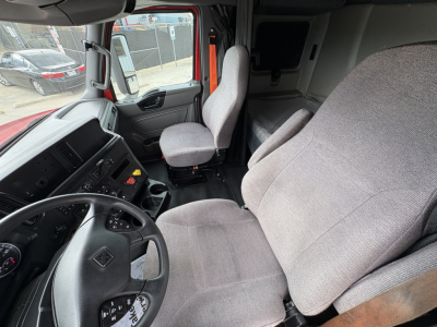 Interior of 2022 International LT truck cab showing steering wheel, driver's seat, passenger seat, and instrument cluster.