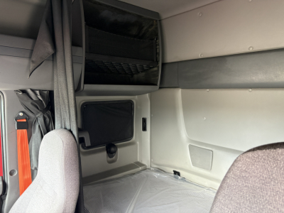 Interior sleeper cab view of a 2022 International LT truck showing storage hatch, window, and seating area.