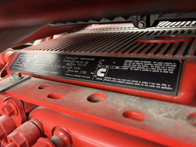 Label on engine or chassis plate with specifications on a red International LT truck showing serial numbers and weights.