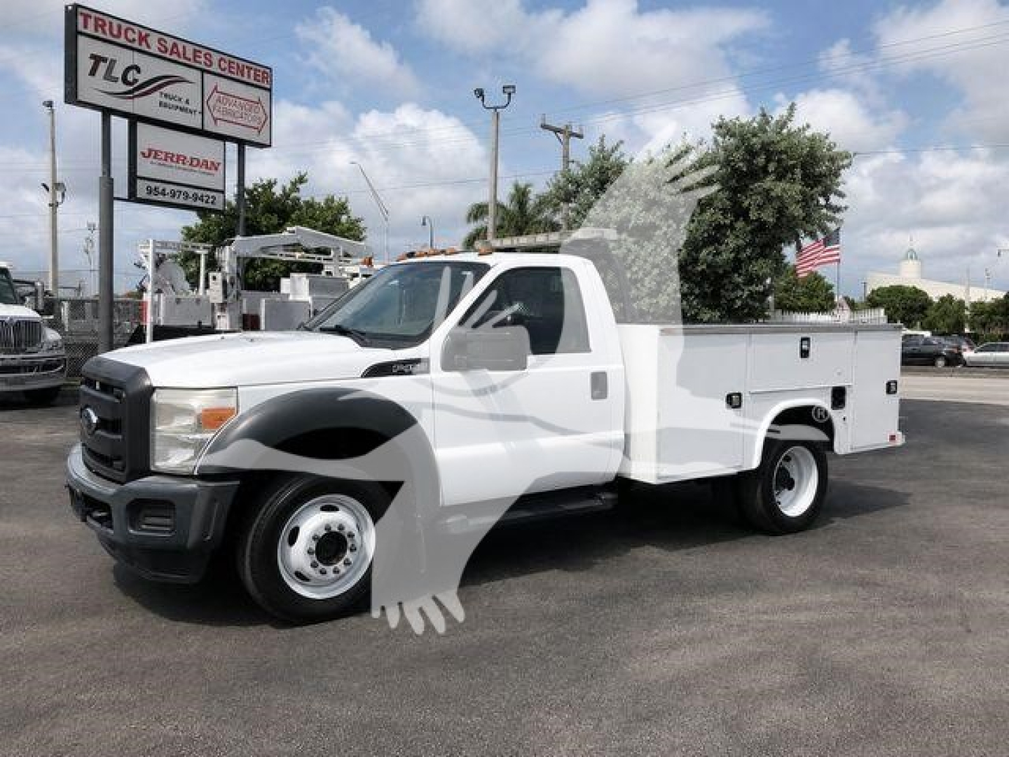 2015 Ford F450 service/utility truck with utility bed, white cab, black grille, and extended service body. Visible text includes TRADE sign in background and TLC Truck Sales Center logo.