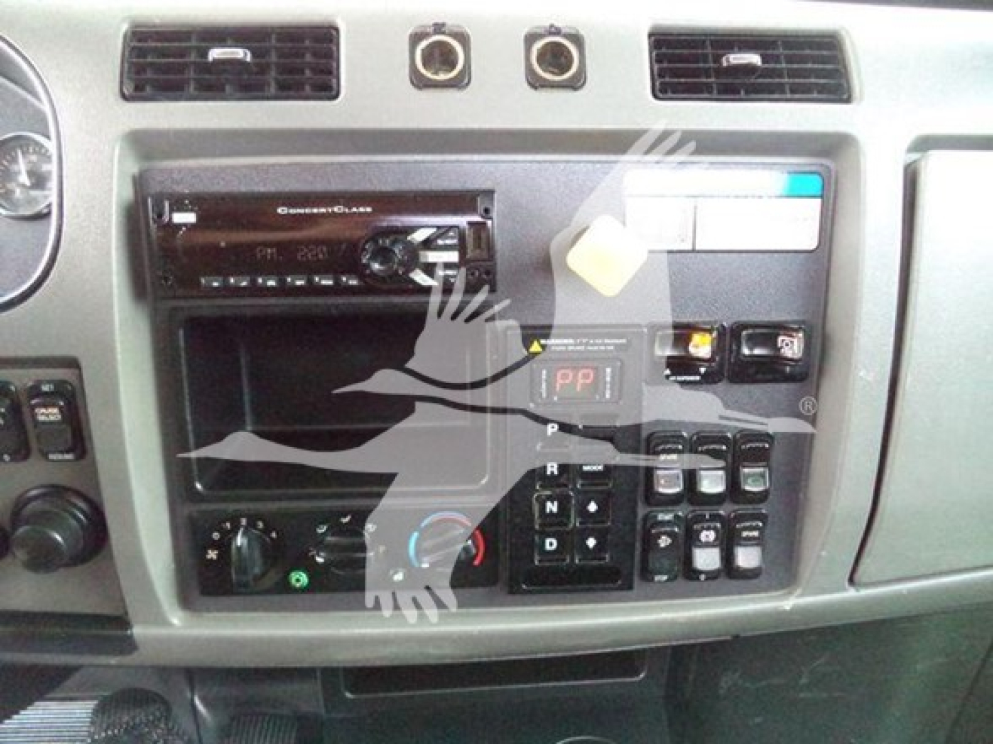 Peterbilt 337 dashboard/center console showing radio head unit and control panel with gear selector and switches.