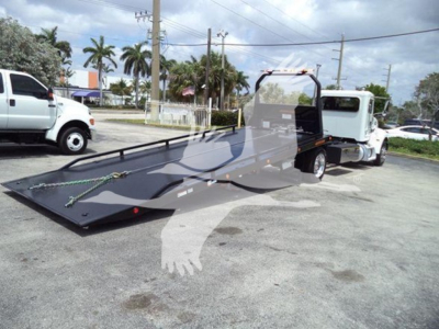 Peterbilt 337 rollback tow truck with extended flatbed trailer, visible VIN and stock details overlayed in image.