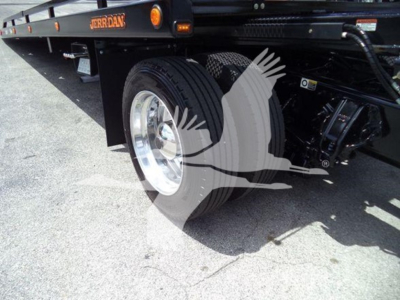 Peterbilt 337 rollback truck rear wheel and chassis showing tire and hydraulic components
