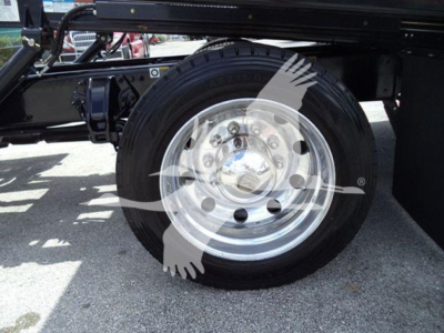 Peterbilt 337 wheel and part of chassis showing aluminum truck wheel with black tire and chrome hubcap.
