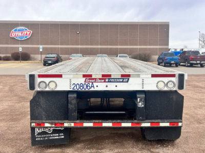 Great Dane flatbed trailer rear view showing license plate area and taillights.