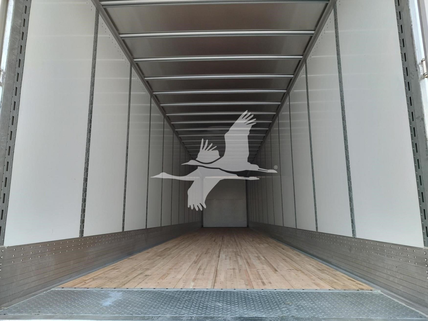 Trailer interior showing empty cargo space with wooden floor and metal sidewalls in a Vanguard Vxp trailer.