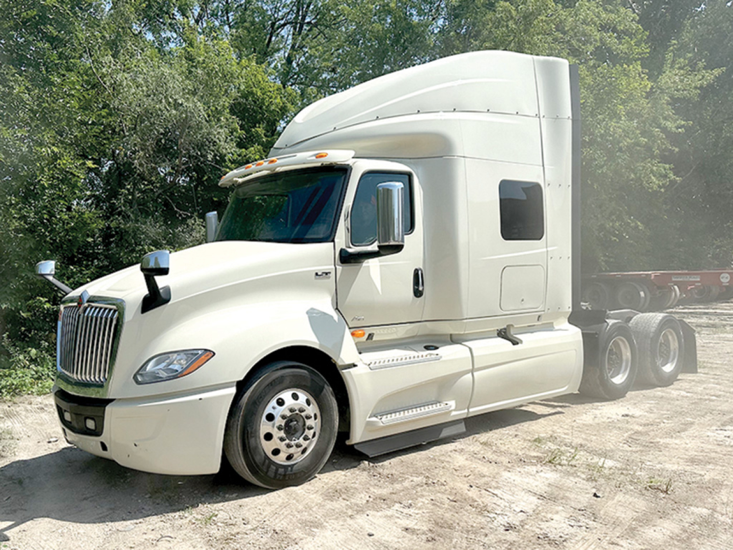 Truck cab and sleeper of a 2019 International LT625 conventional sleeper tractor, white exterior, side mirrors, chrome wheel covers, dual rear axles, KN054548 VIN readable on listing.