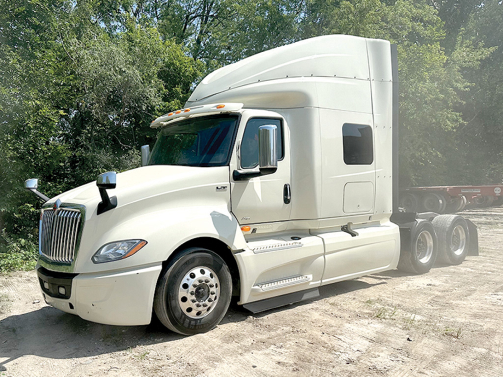 Truck cab and sleeper of a 2019 International LT625 conventional sleeper tractor, white exterior, side mirrors, chrome wheel covers, dual rear axles, KN054548 VIN readable on listing.