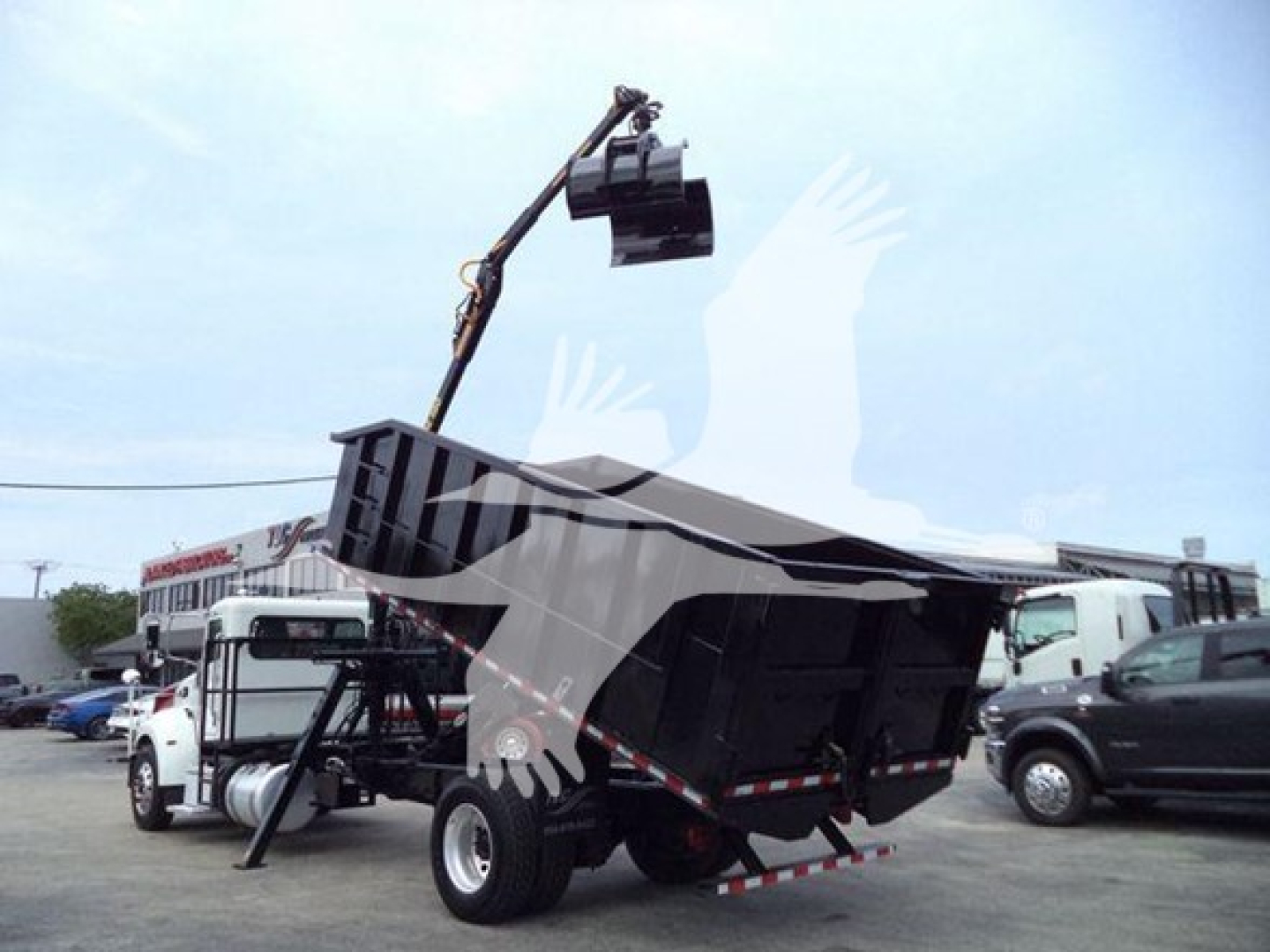 Peterbilt 337 grapple truck in side view with lifting attachment and dump bed, 2020 model year
