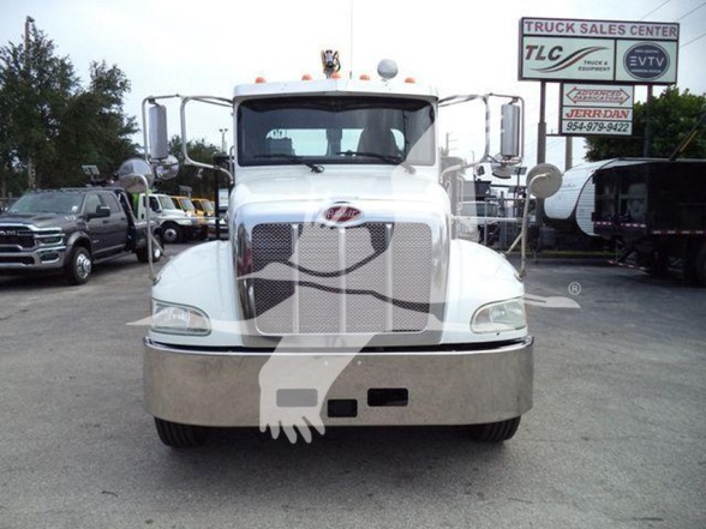 Front view of a white 2020 Peterbilt 337 grapple truck with chrome grille and bumper, dealership lot background, stock and VIN visible.