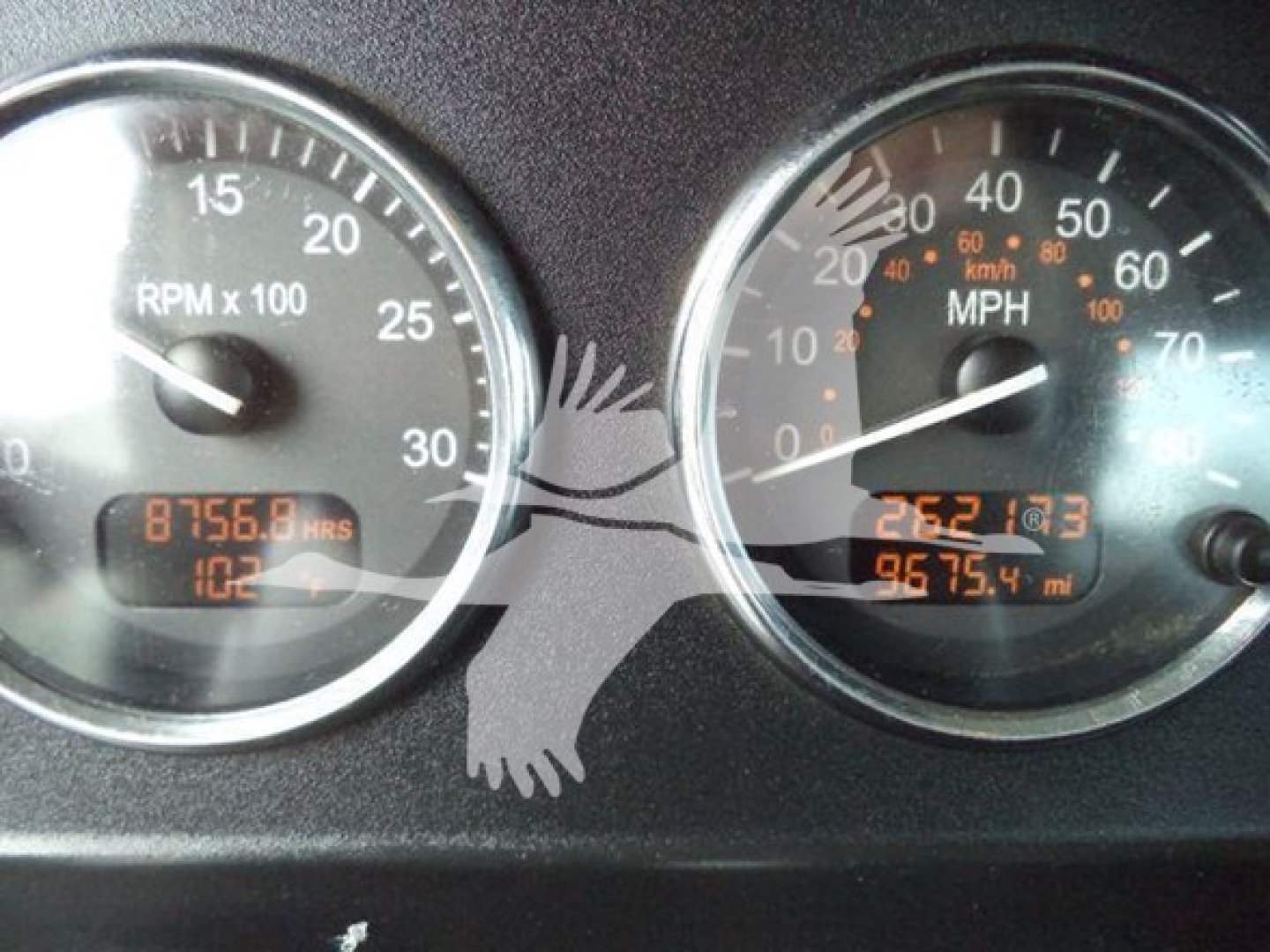Peterbilt 337 gauge cluster showing RPM x1000 gauge and MPH gauge with digital odometer readings (8756.8 hrs, 106? miles, 675.4?).