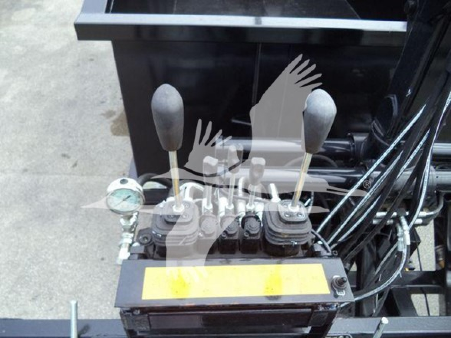 Peterbilt 337 grapple truck control levers with warning label and gauges in foreground, hydraulic levers and cables visible.