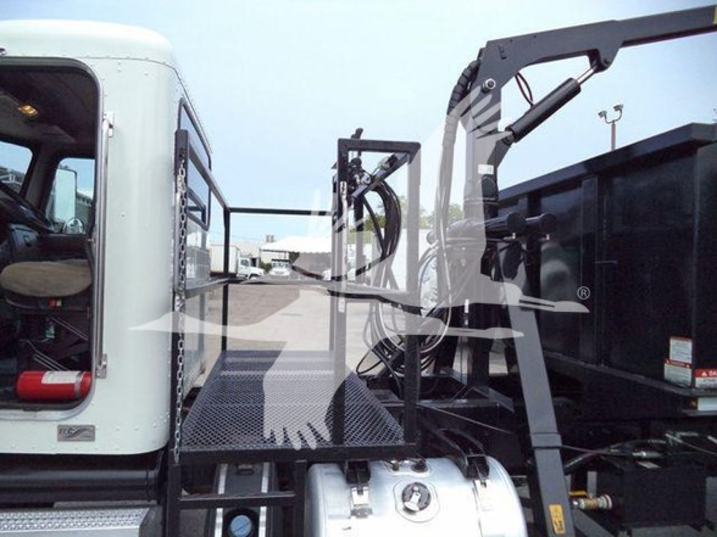 Peterbilt 337 truck with grapple truck bed and hydraulic crane, side view showing operator cab and metal platform.