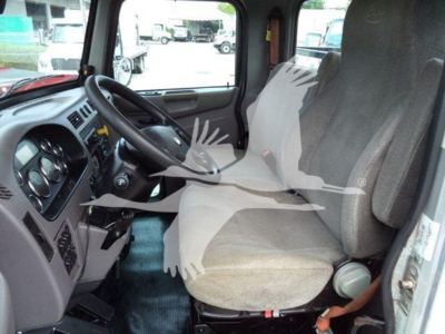 Cab interior of a 2020 Peterbilt 337 truck with two front seats and steering wheel, dashboard, and gear shift visible.
