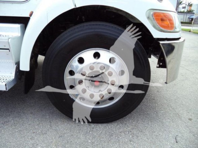 Peterbilt 337 front wheel and fender showing large steel wheel with hub, tire, and part of light assembly.