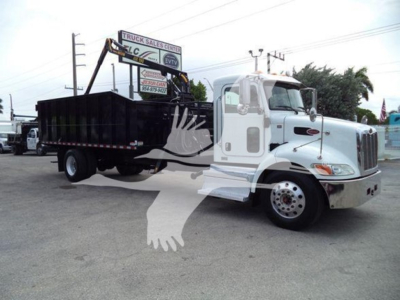 Peterbilt 337 grapple truck in white cab with black dump bed, side view showing crane attachment and windowed cab.