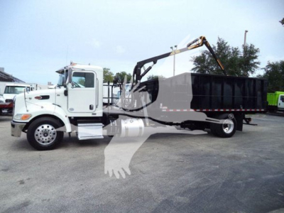 Peterbilt 337 truck with a grapple and dump bed in service showing side view of cab and chassis.
