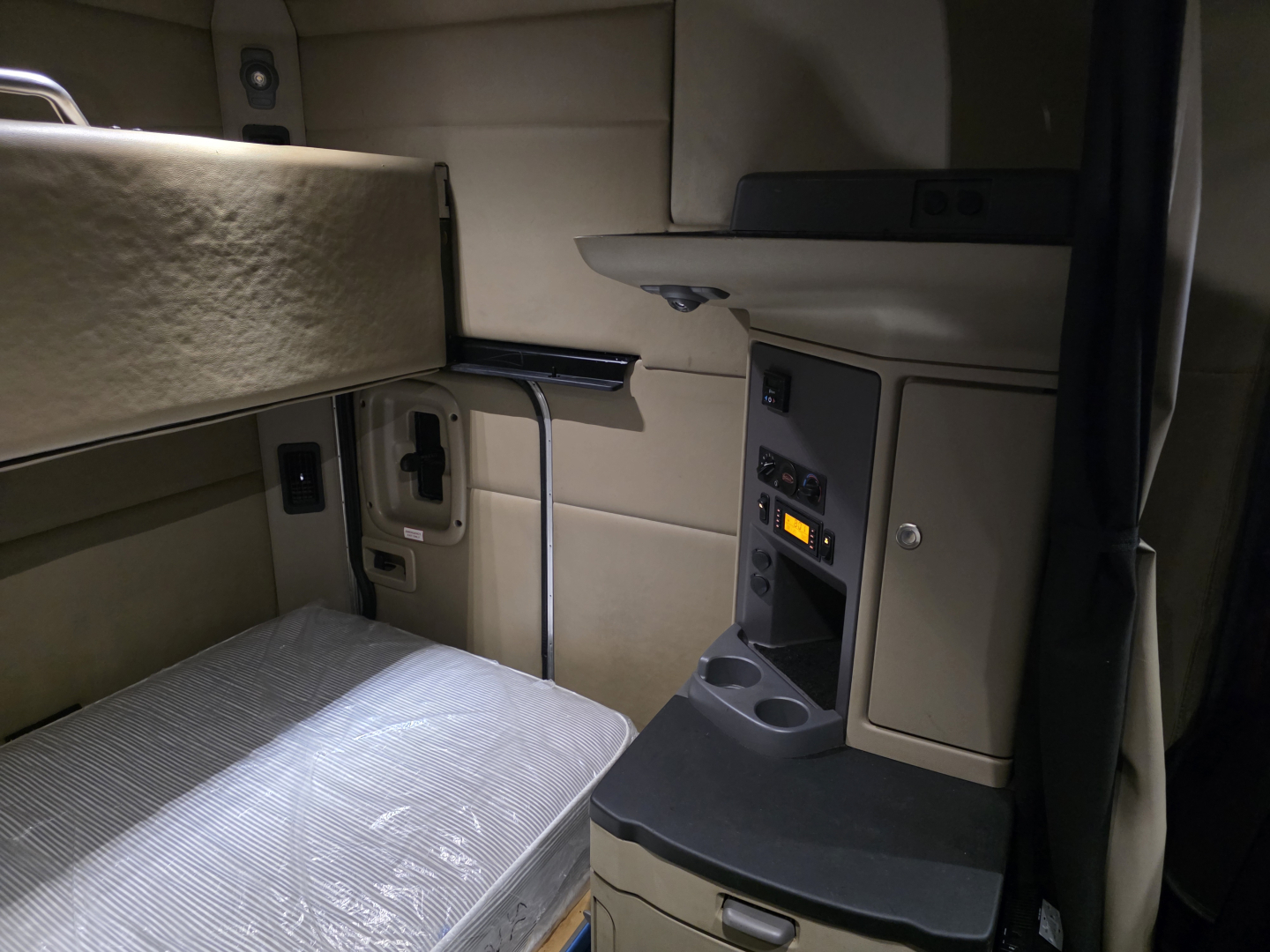 Cabin interior of a 2016 Peterbilt 579 with sleeper area and dashboard elements visible.