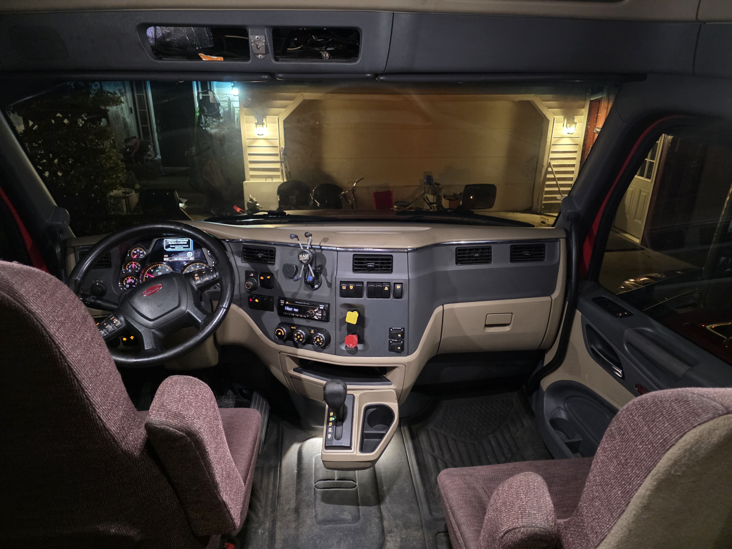 Interior of a 2016 Peterbilt 579 cab showing dashboard controls, steering wheel, center console, and driver seat.