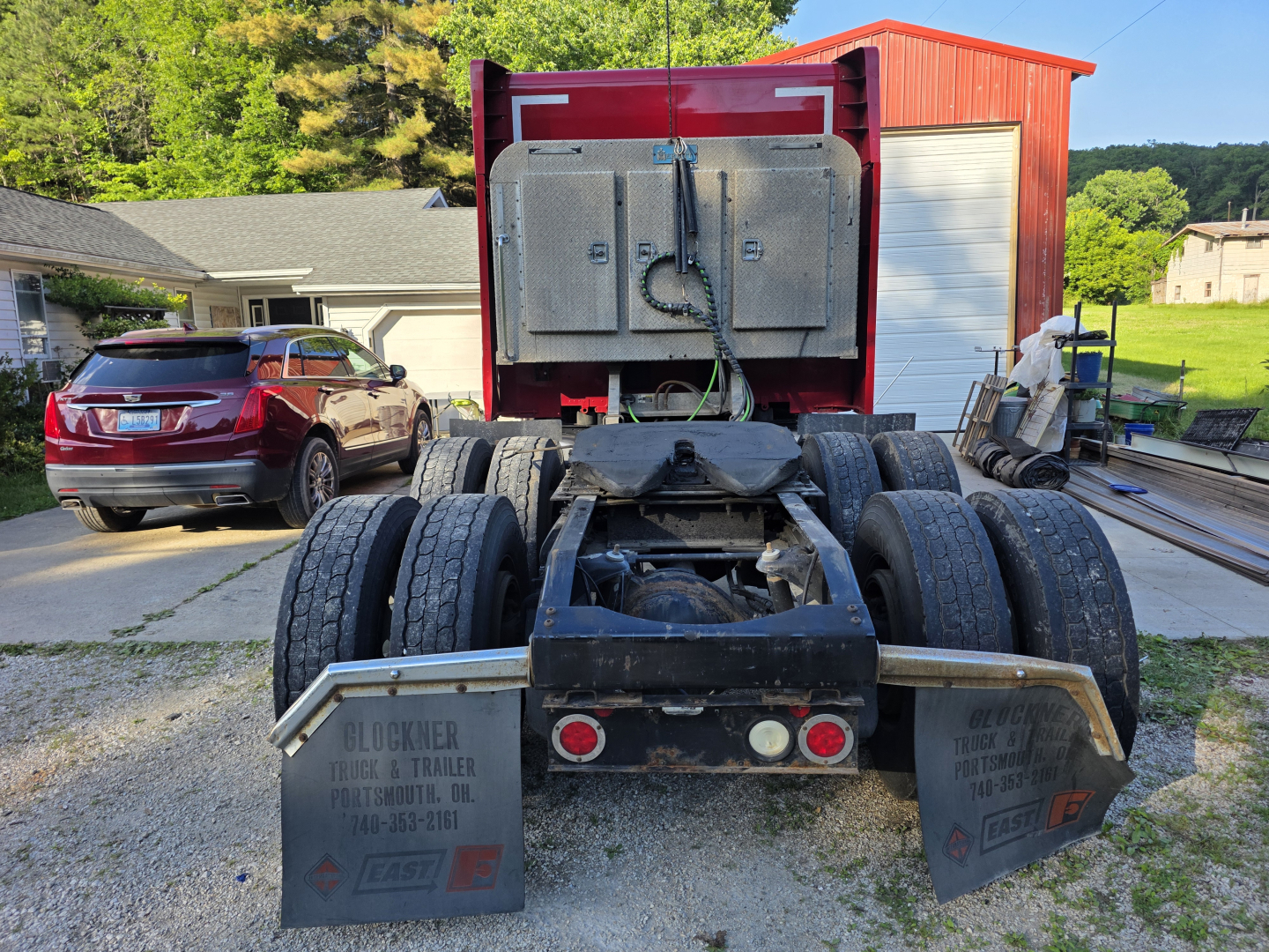 Peterbilt 579 rear view showing dual rear wheels and trailer hitch area, with mud flaps and auxiliary lights