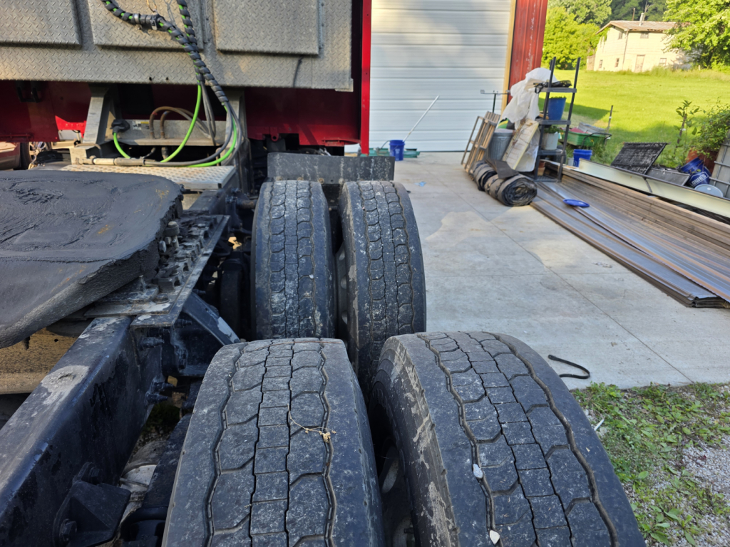 Peterbilt 579 truck chassis with dual rear axles and worn tires visible.