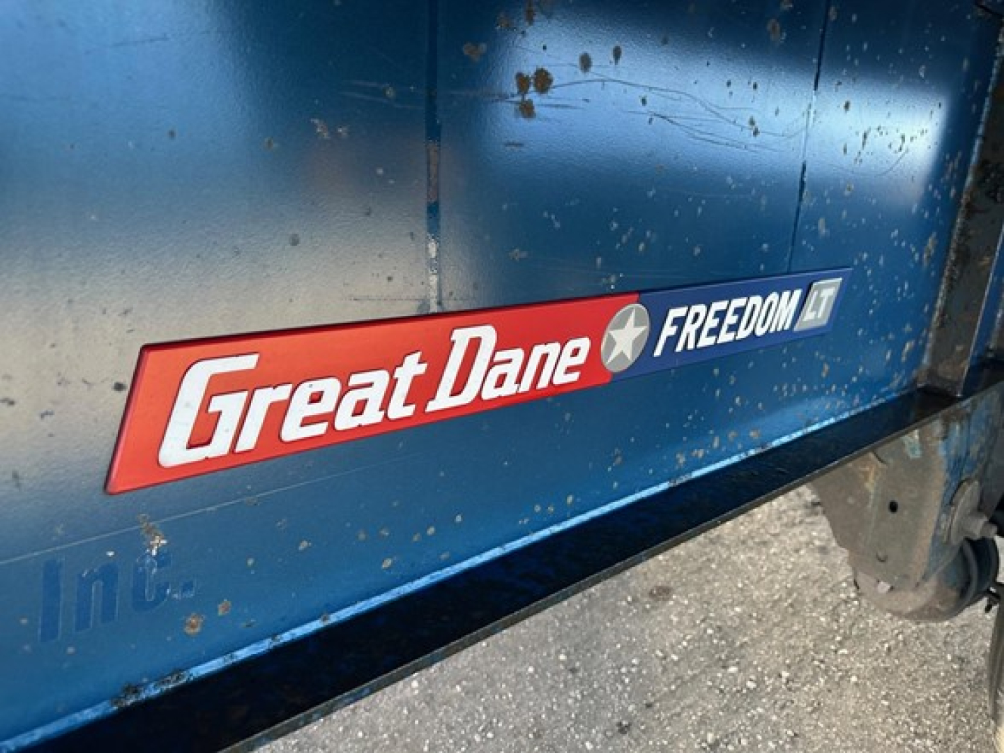 Great Dane Freedom LT trailer side with logo emblem and blue paint.